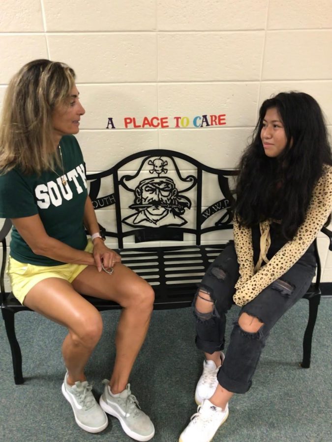 Health teacher Lisa Hayden and junior Skyler Simon share a conversation on a Friendship Bench.