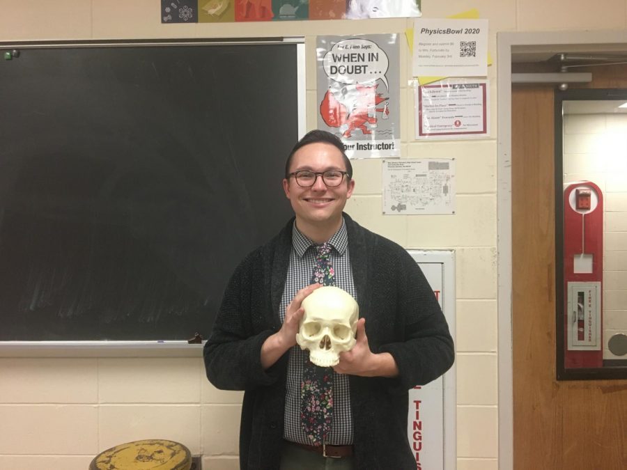Mr Young shows a skull to his forensics science class.