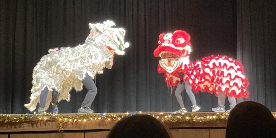 Lion dance act members circling each other during a dance.