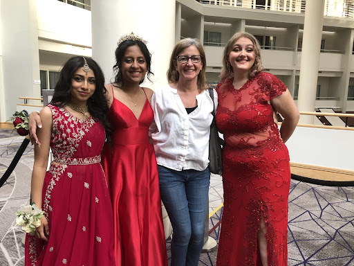 Ms. Kerry Kemo with seniors dressed for prom: Kavya Kapoor, Anoushka Paul and Faith Falkowitz