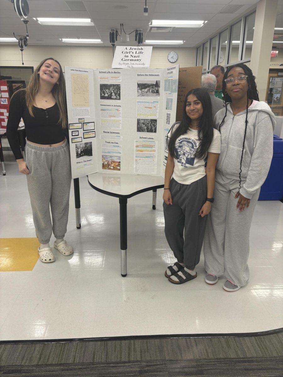 Judy Sakran ('27), Arya Patel ('27) and Kennedy Sirmans ('27) posing with their project.